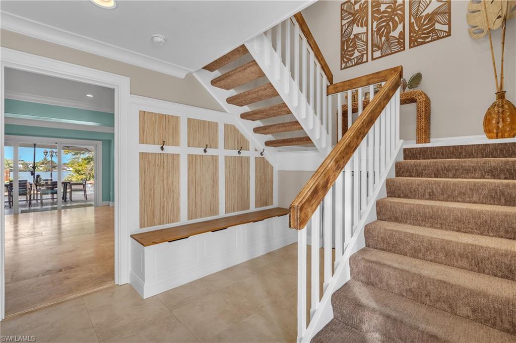 3001 50th Street Southwest Naples, FL 34116 - Photo 28 of 46 a view of staircase with lots of frames on wall and a dining table