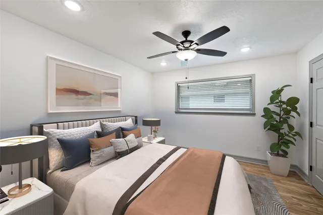 a bedroom with a large bed and a window