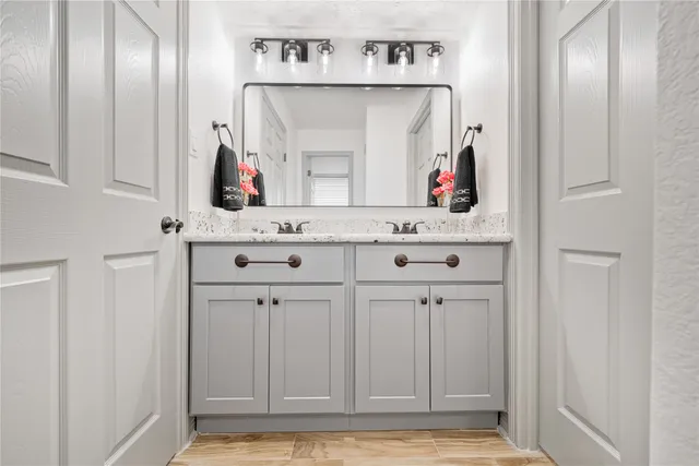 a view of cabinets and entryway with wooden floor