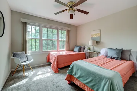a bedroom with two beds and a chandelier