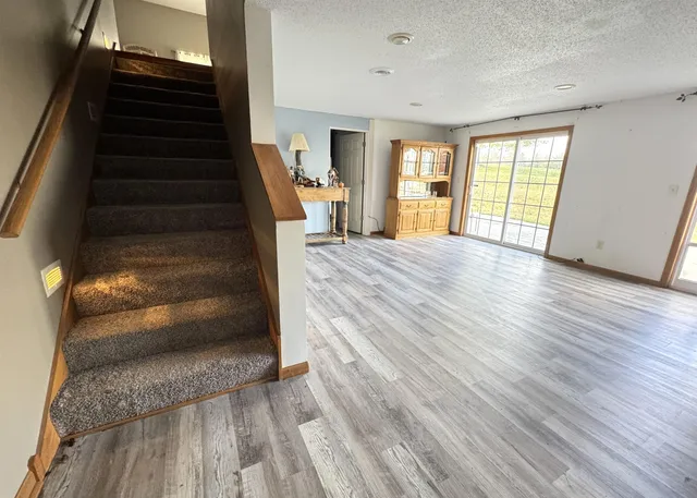 a view of an entryway with wooden floor and door