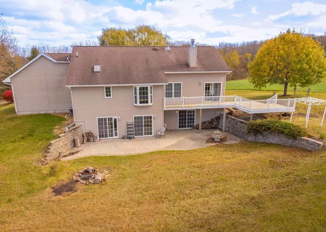 a view of a house with pool and a yard