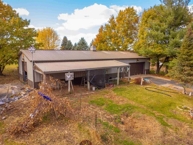 a view of a house with pool and sitting area