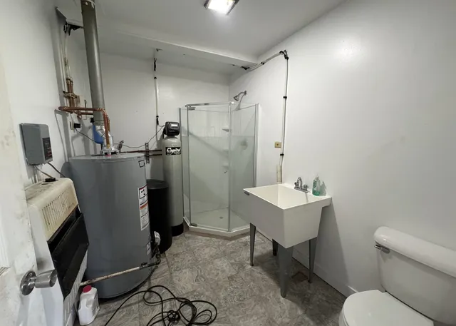 a bathroom with a sink toilet and shower