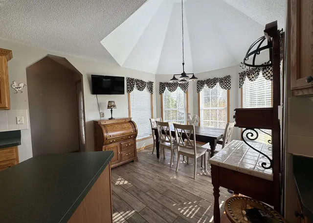 a living room with furniture a flat screen tv and a table