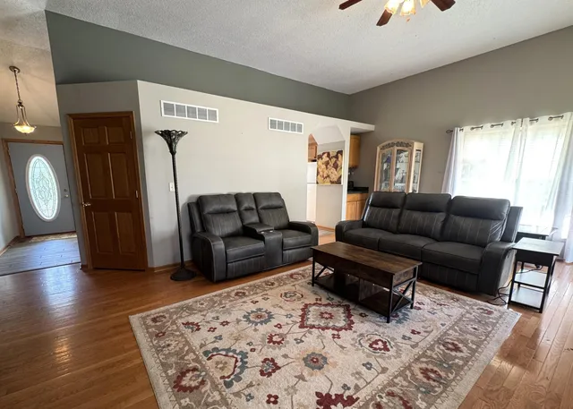 a living room with furniture window and wooden floor