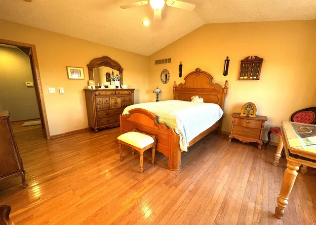 a spacious bedroom with a bed and a table in it