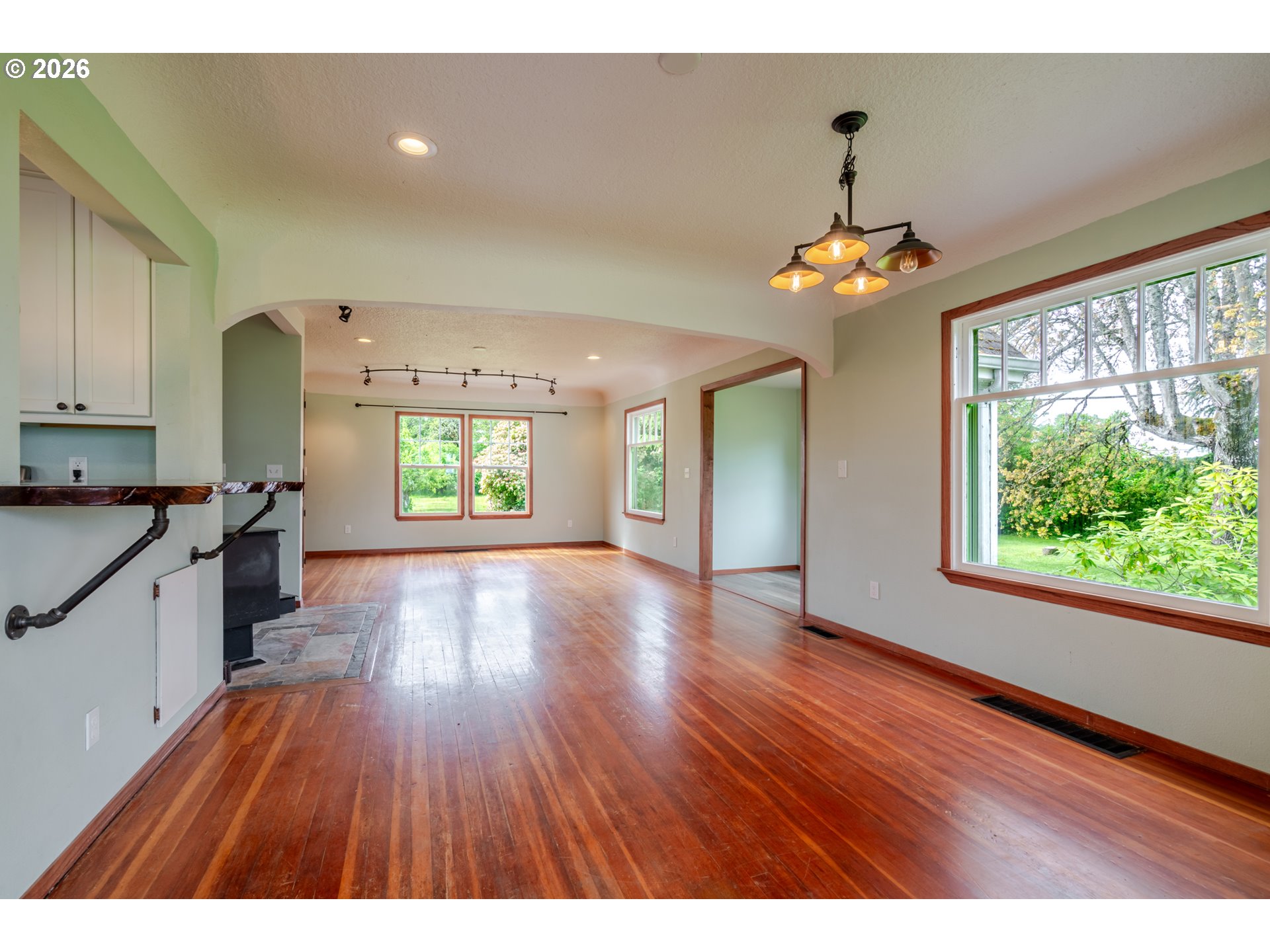 34965 Brewster Road Lebanon, OR 97355 - Photo 12 of 48 a view of an empty room with wooden floor and a window
