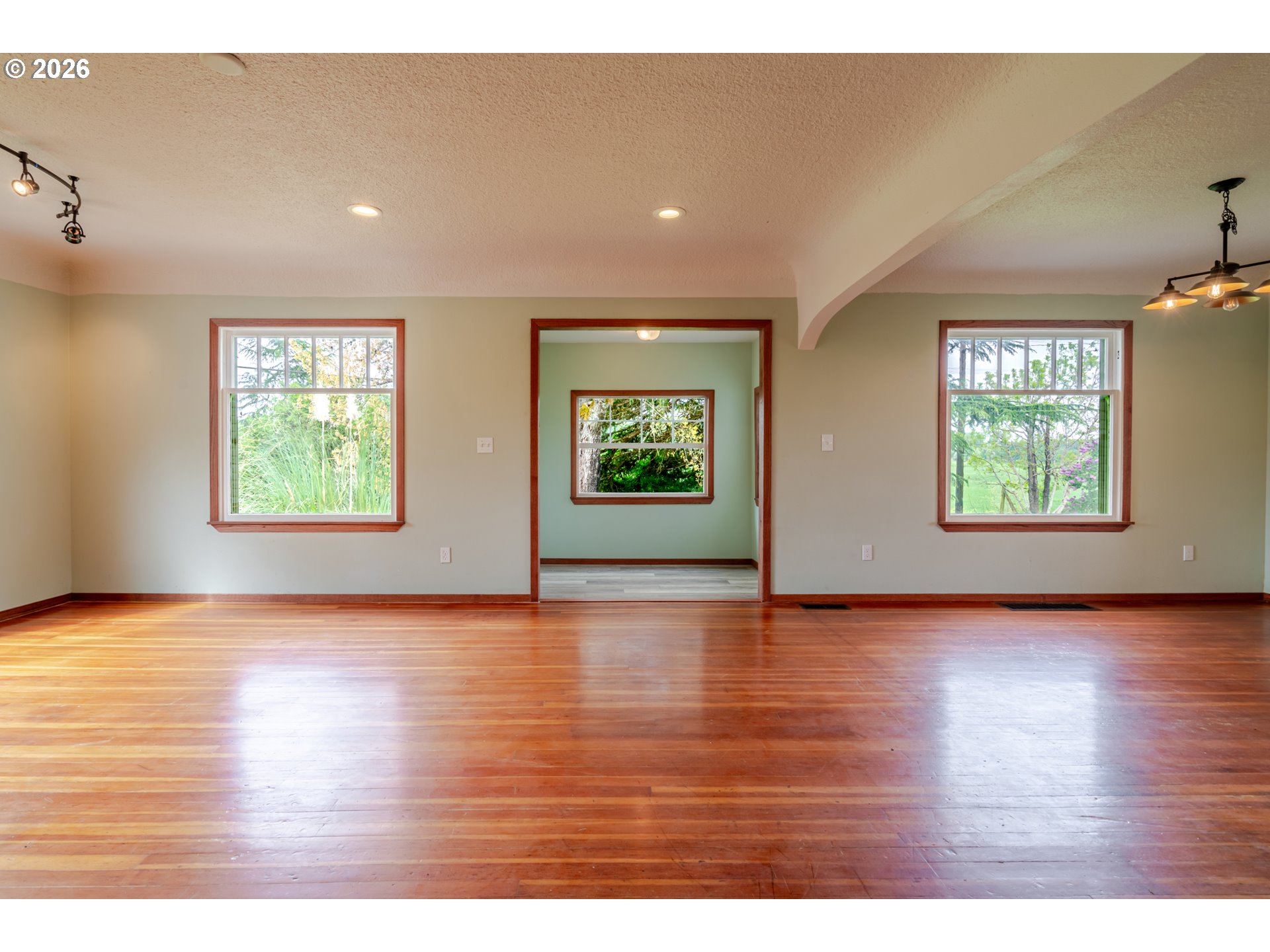 34965 Brewster Road Lebanon, OR 97355 - Photo 13 of 48 an empty room with wooden floor and windows