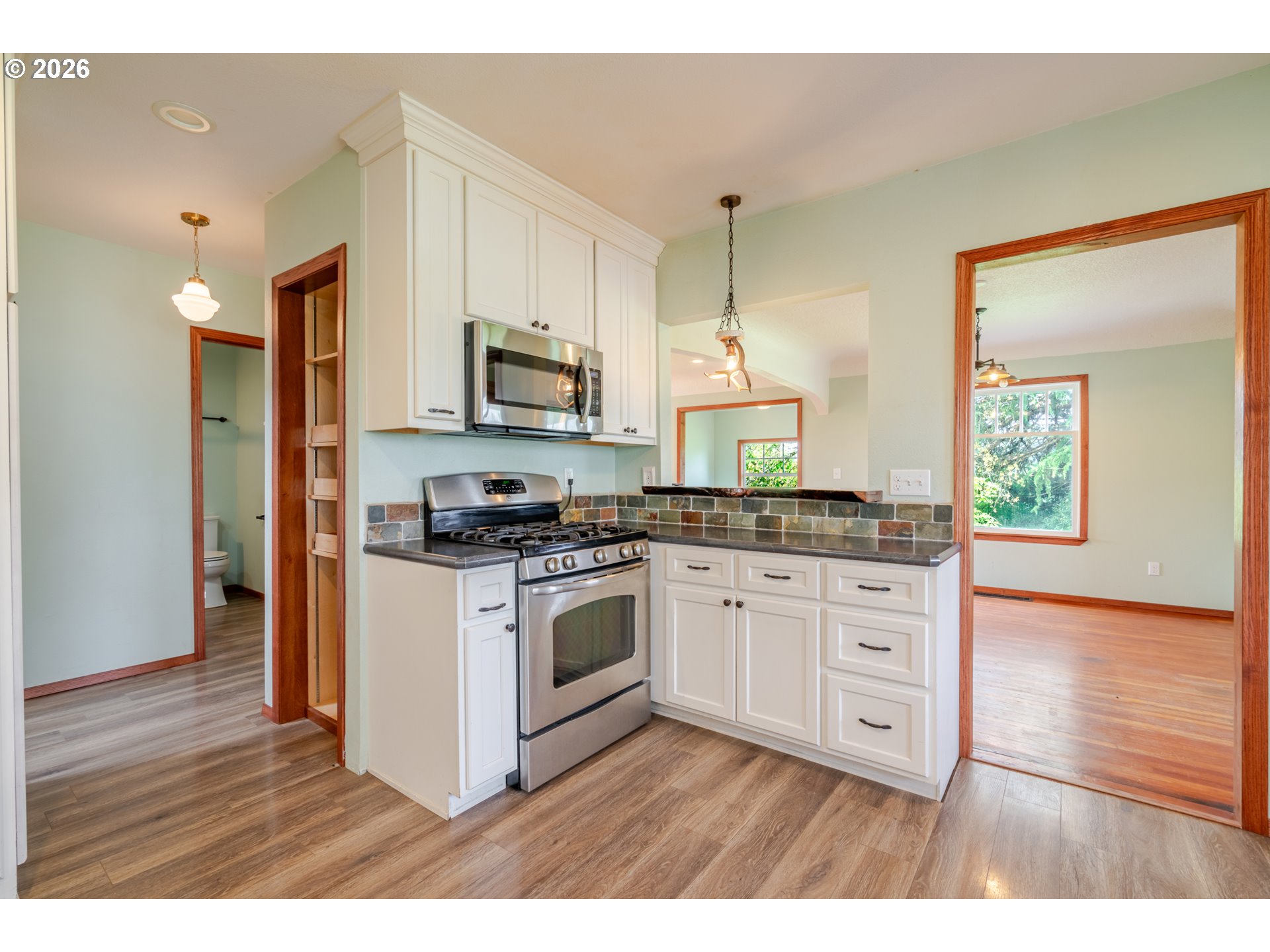 34965 Brewster Road Lebanon, OR 97355 - Photo 16 of 48 a kitchen with stainless steel appliances granite countertop a stove a sink and a microwave