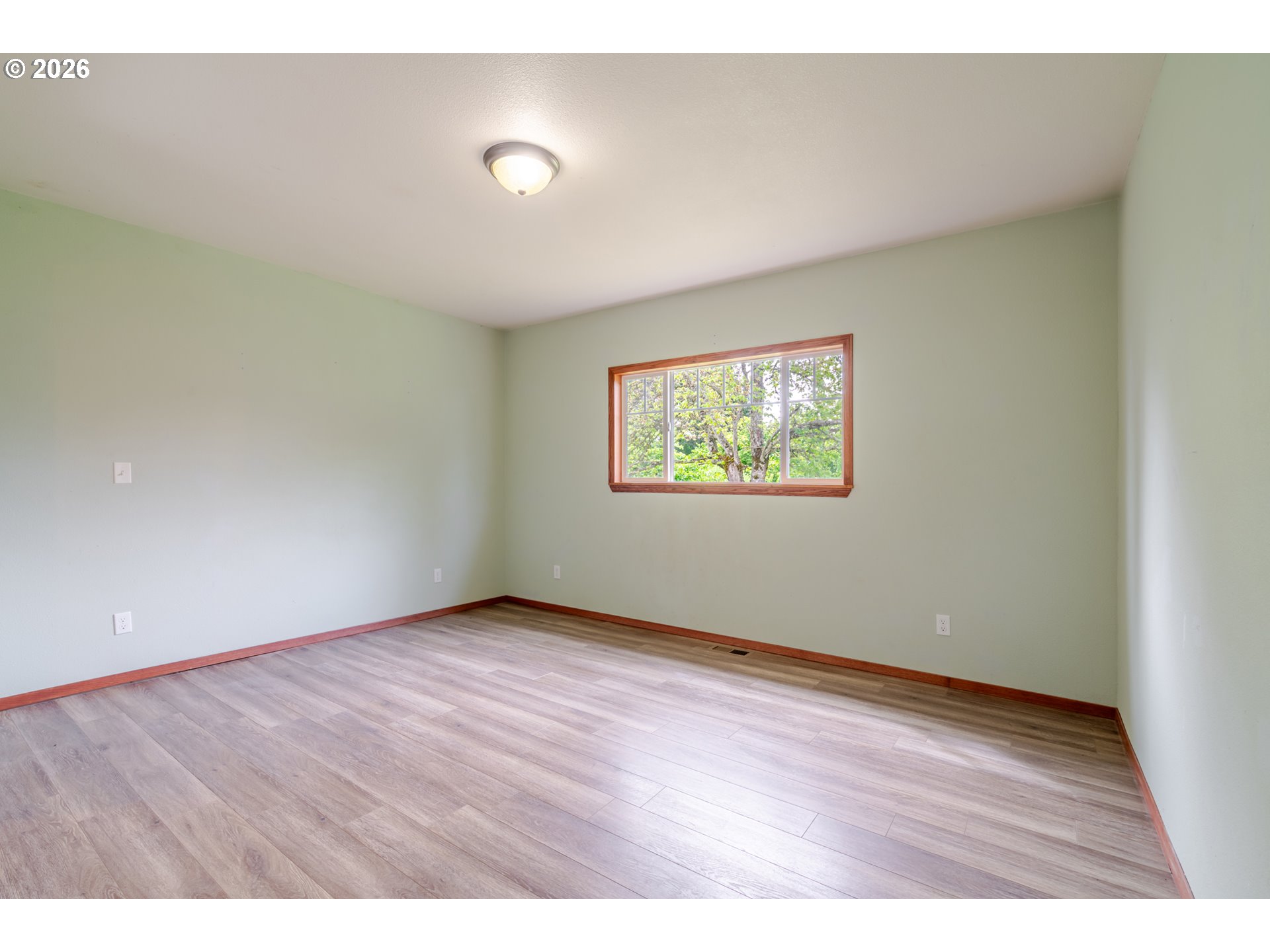 34965 Brewster Road Lebanon, OR 97355 - Photo 21 of 48 an empty room with wooden floor and windows