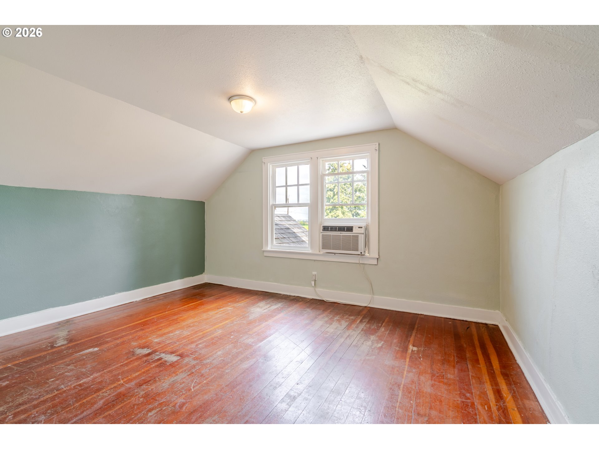 34965 Brewster Road Lebanon, OR 97355 - Photo 23 of 48 a view of an empty room with wooden floor and a window