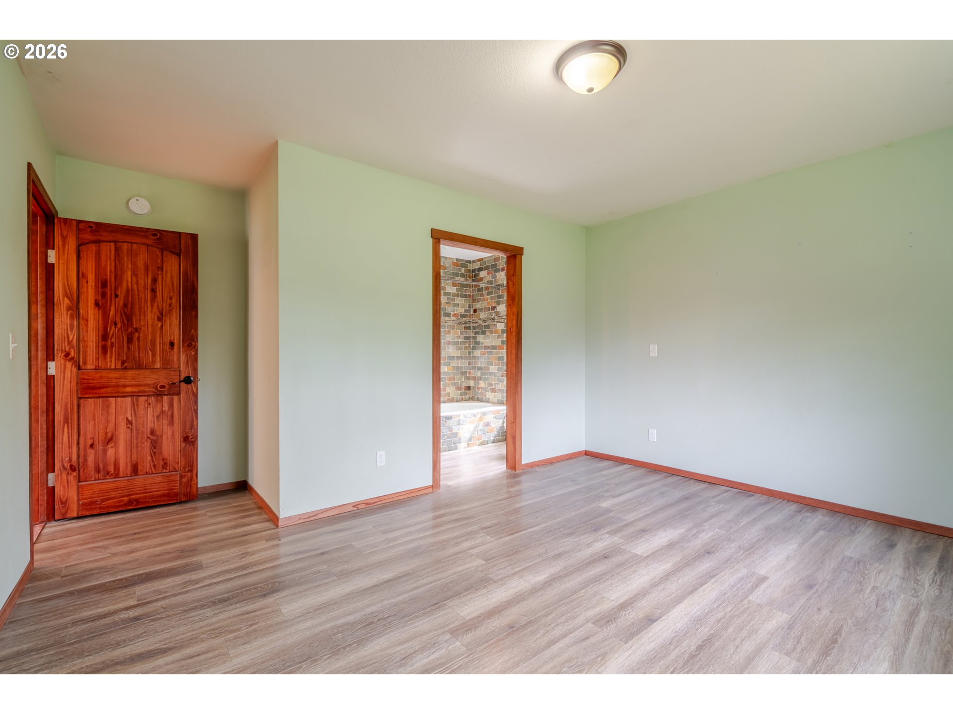 34965 Brewster Road Lebanon, OR 97355 - Photo 27 of 48 a view of an empty room with wooden floor and a window