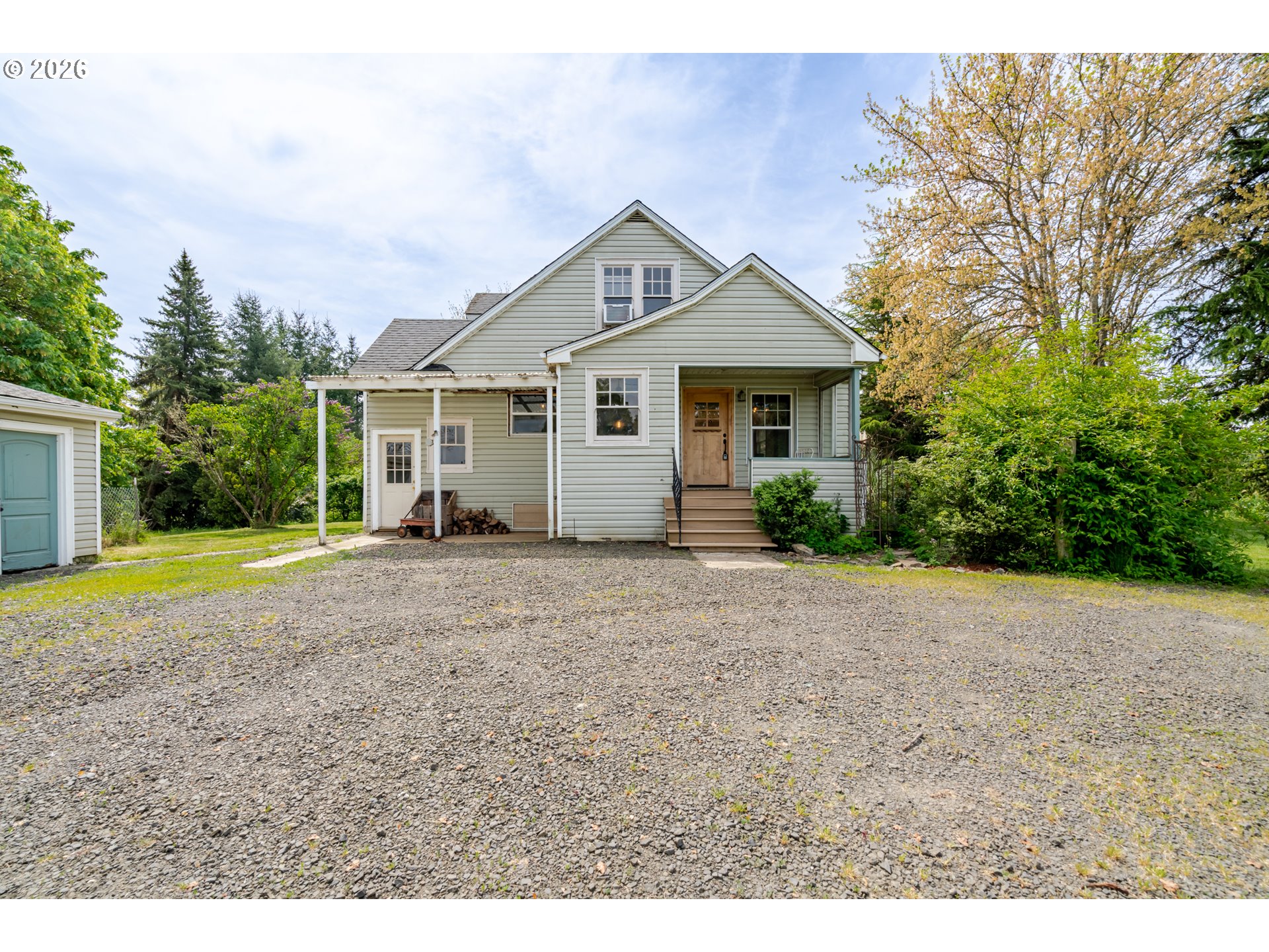 34965 Brewster Road Lebanon, OR 97355 - Photo 3 of 48 a view of a house with a yard and large trees