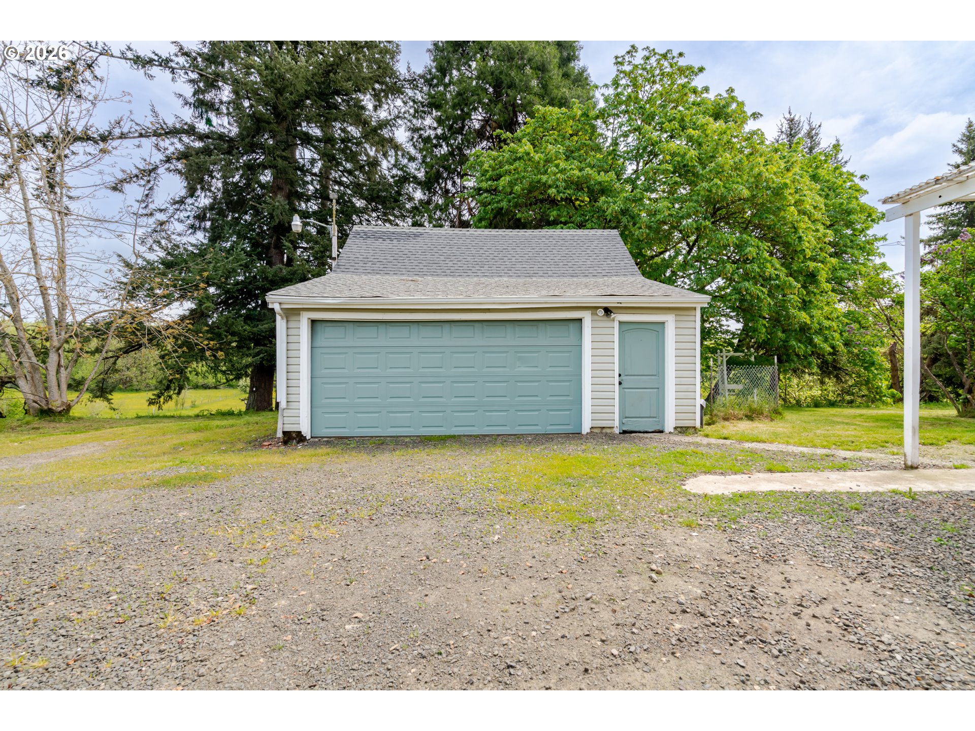34965 Brewster Road Lebanon, OR 97355 - Photo 43 of 48 a front view of a house with a yard and garage