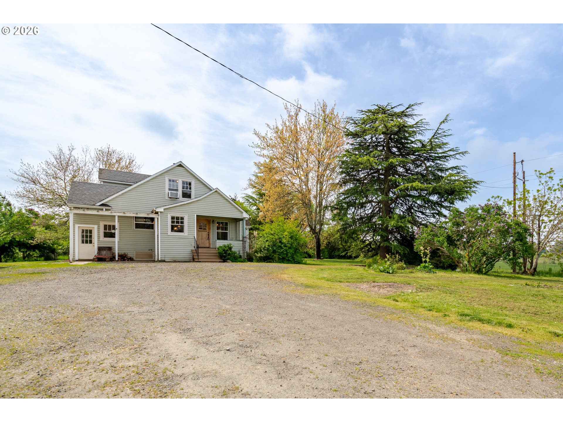 34965 Brewster Road Lebanon, OR 97355 - Photo 5 of 48 a front view of a house with a garden and yard