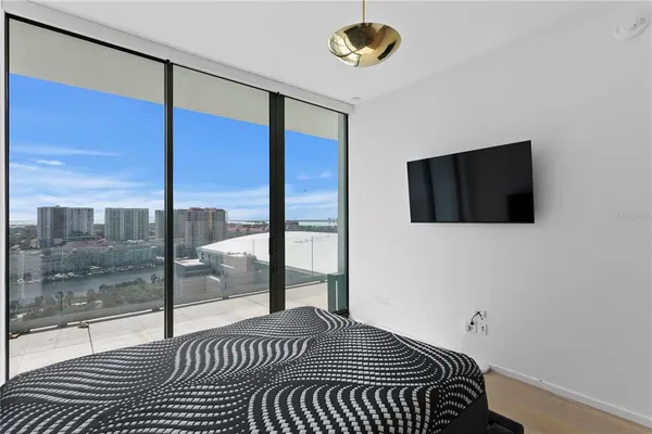 a bedroom with a large bed and a window