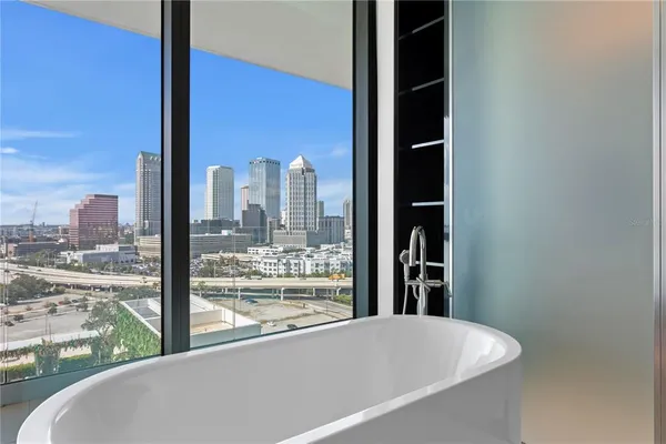 a bathroom with a large tub sink and mirror