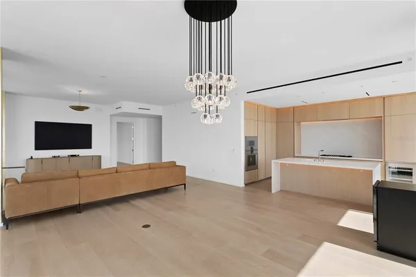 a living room with furniture tv and a large window