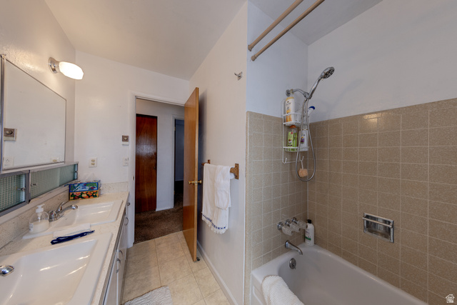 738 Locust Lane Moab, UT 84532 - Photo 11 of 25 Full bath with double vanity, bathing tub / shower combination, and light tile patterned floors
