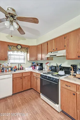 a kitchen with cabinets a sink and appliances