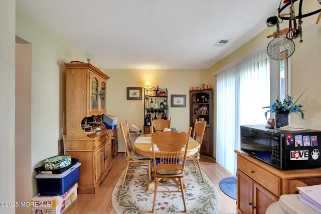 a view of a dining room with furniture and a chandelier