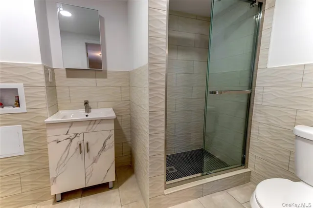 a white toilet sitting next to a bathroom sink and tub
