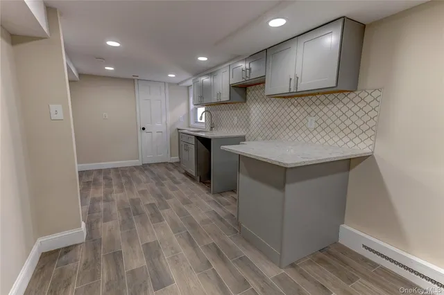 a kitchen with kitchen island sink stove and cabinets