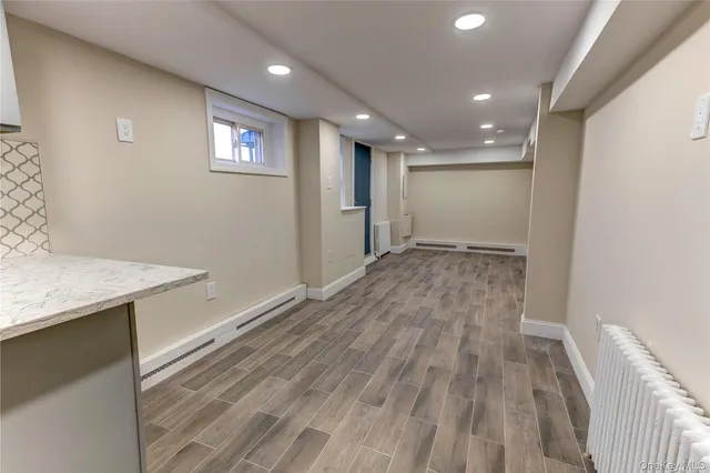 a view of an empty room with window and closet area