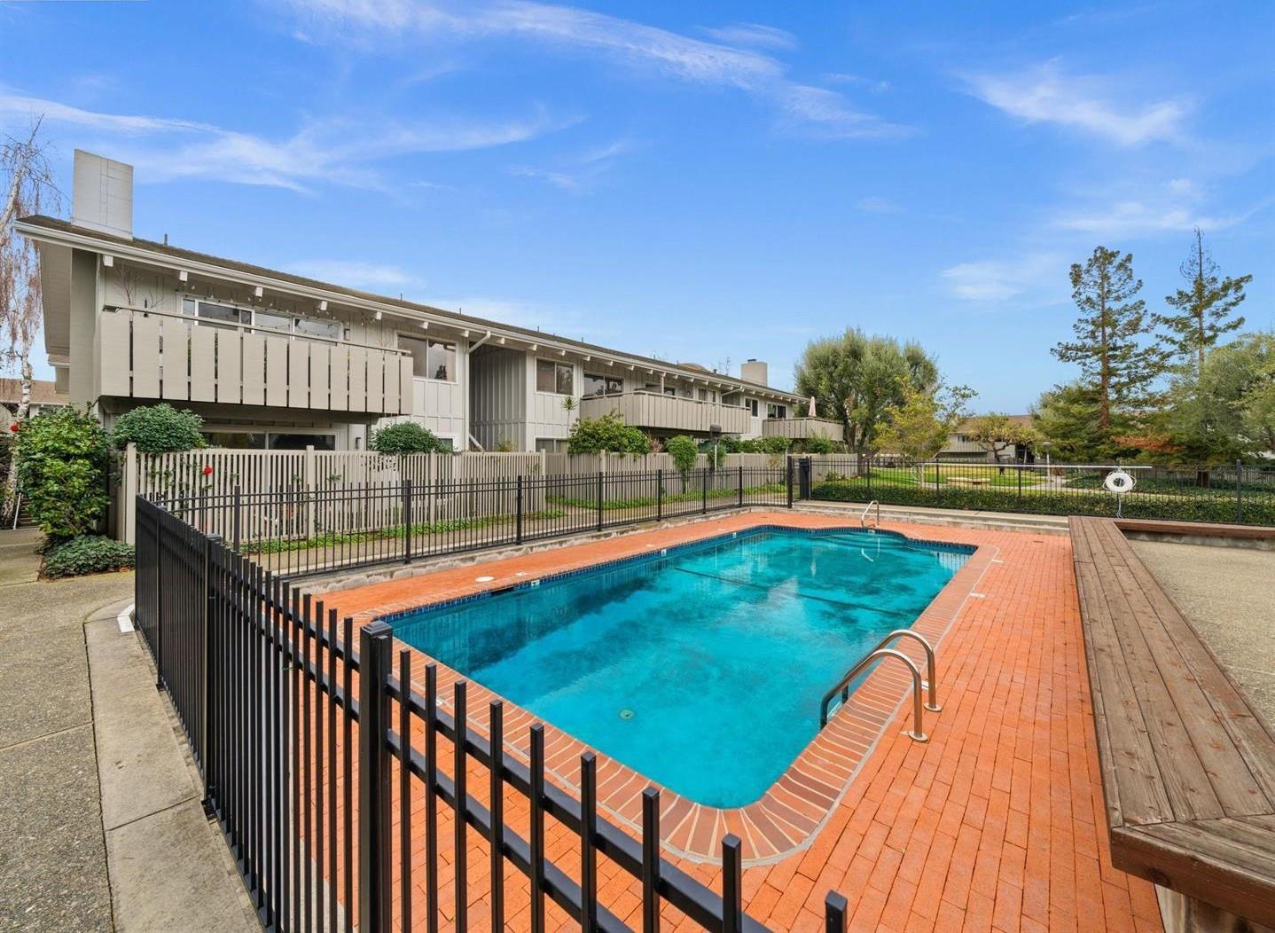 255 South Rengstorff Avenue, Unit 2 Mountain View, CA 94040 - Photo 22 of 25 a view of a swimming pool with a lounge chairs