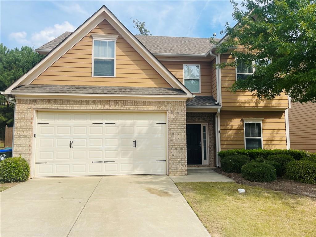 183 Mount Moriah Road Ball Ground, GA 30107 - Photo 1 of 1 a view of a house with a yard and garage