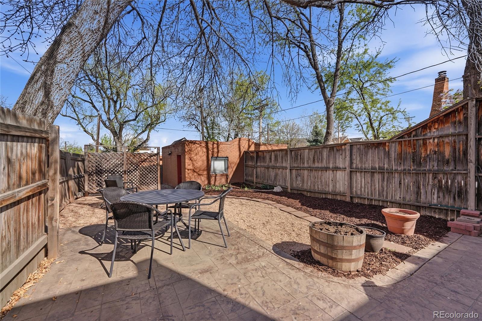 3294 Quitman Street Denver, CO 80212 - Photo 19 of 39 a backyard of a house with table and chairs