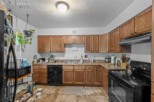 a kitchen with a sink a stove and cabinets