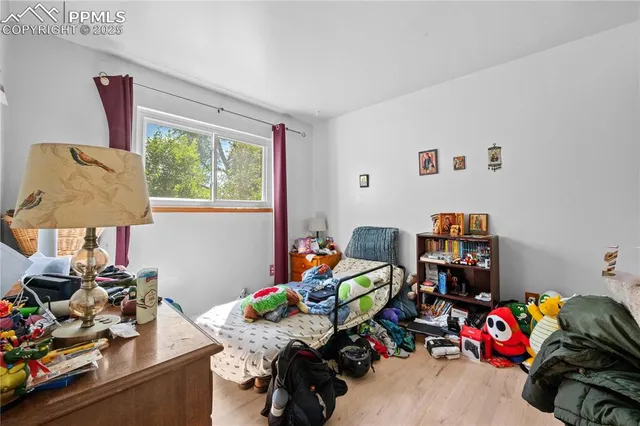 a kids room with toys and a wooden floor