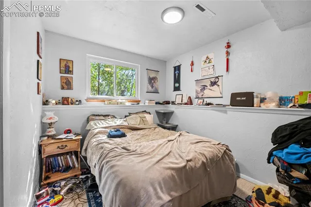 a bedroom with a bed and a book shelf