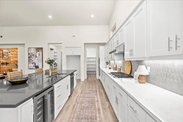 a kitchen with stainless steel appliances a sink and cabinets
