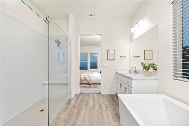 a spacious bathroom with sinks mirror and a bathtub