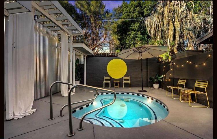 354 East Stevens Road Palm Springs, CA 92262 - Photo 5 of 15 a view of a swimming pool with a patio and a garden