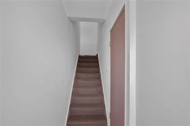 a bedroom with a bed and a refrigerator