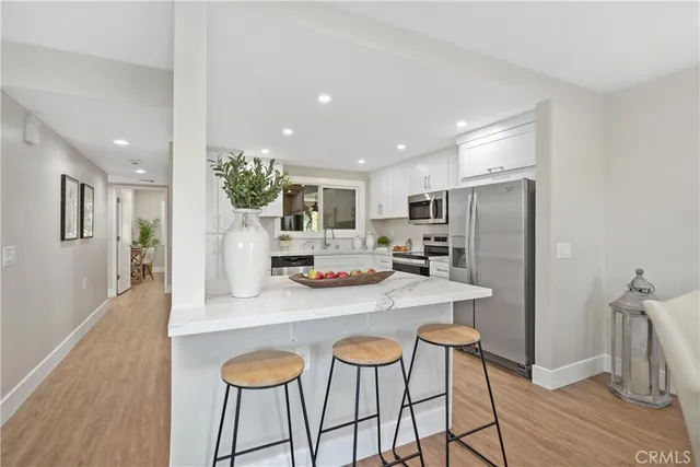 a kitchen with granite countertop a refrigerator and a sink