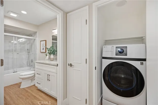 a bedroom with a bed a mirror and a lamp