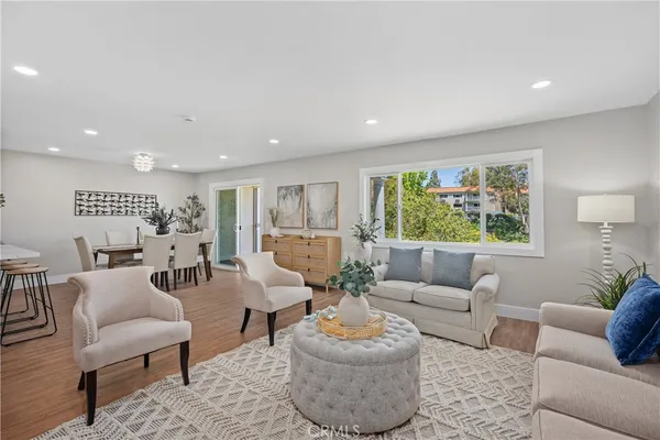 a living room with furniture and a potted plant