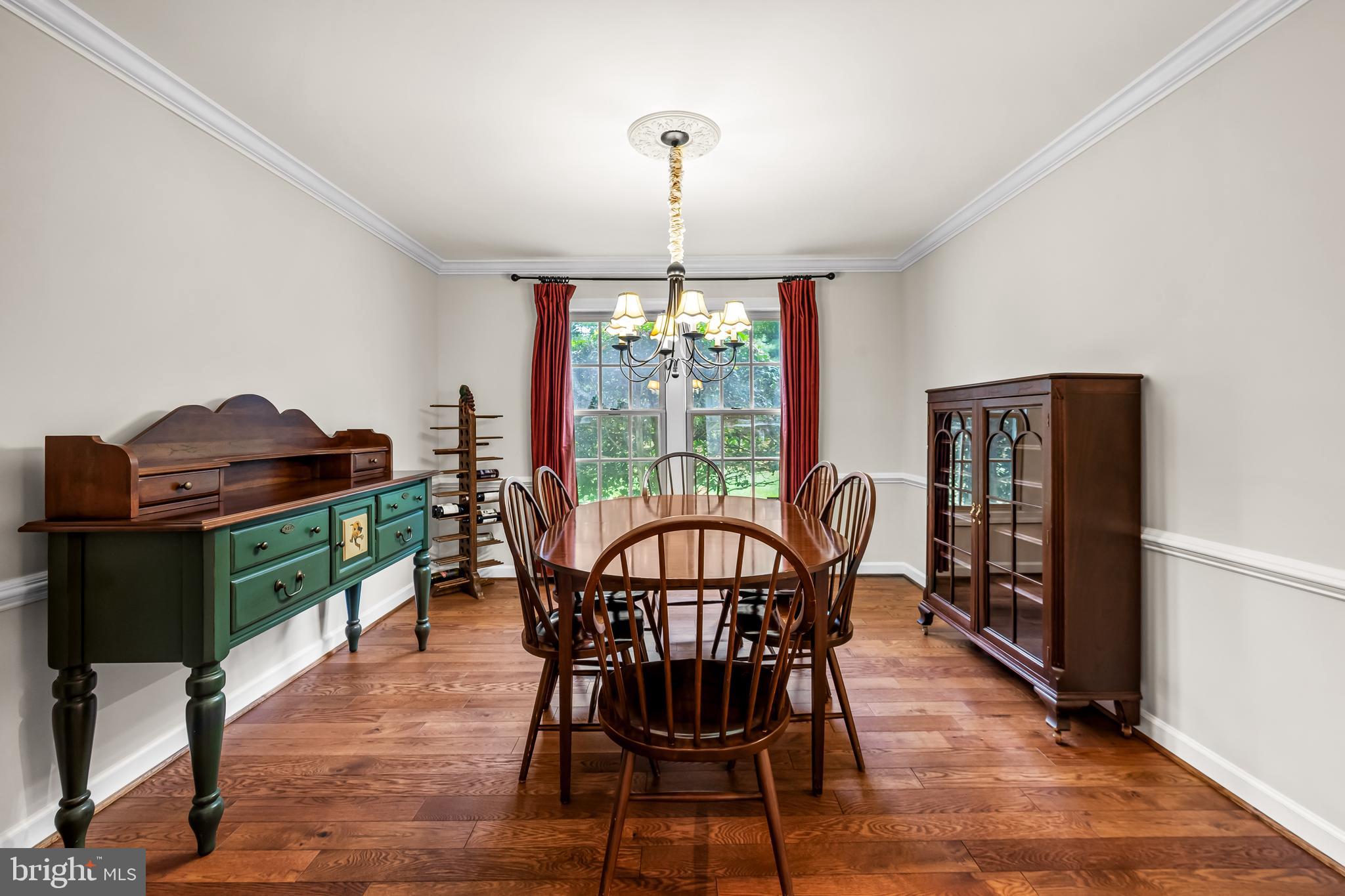 8315 Saddle Ridge Terrace Ellicott City, MD 21043 - Photo 13 of 62 a view of a dining room with furniture window and wooden floor