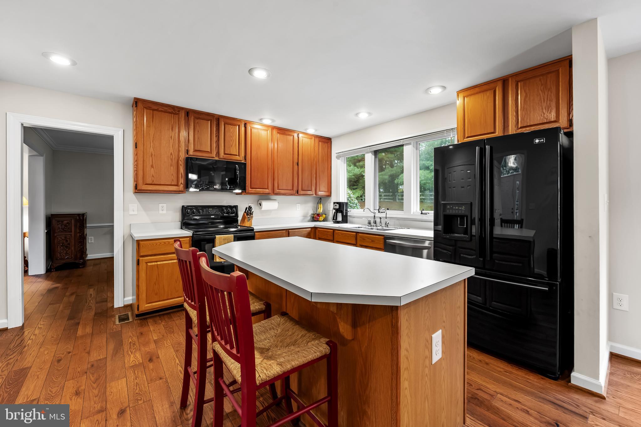 8315 Saddle Ridge Terrace Ellicott City, MD 21043 - Photo 15 of 62 a kitchen with stainless steel appliances granite countertop a refrigerator a stove top oven a sink and dishwasher