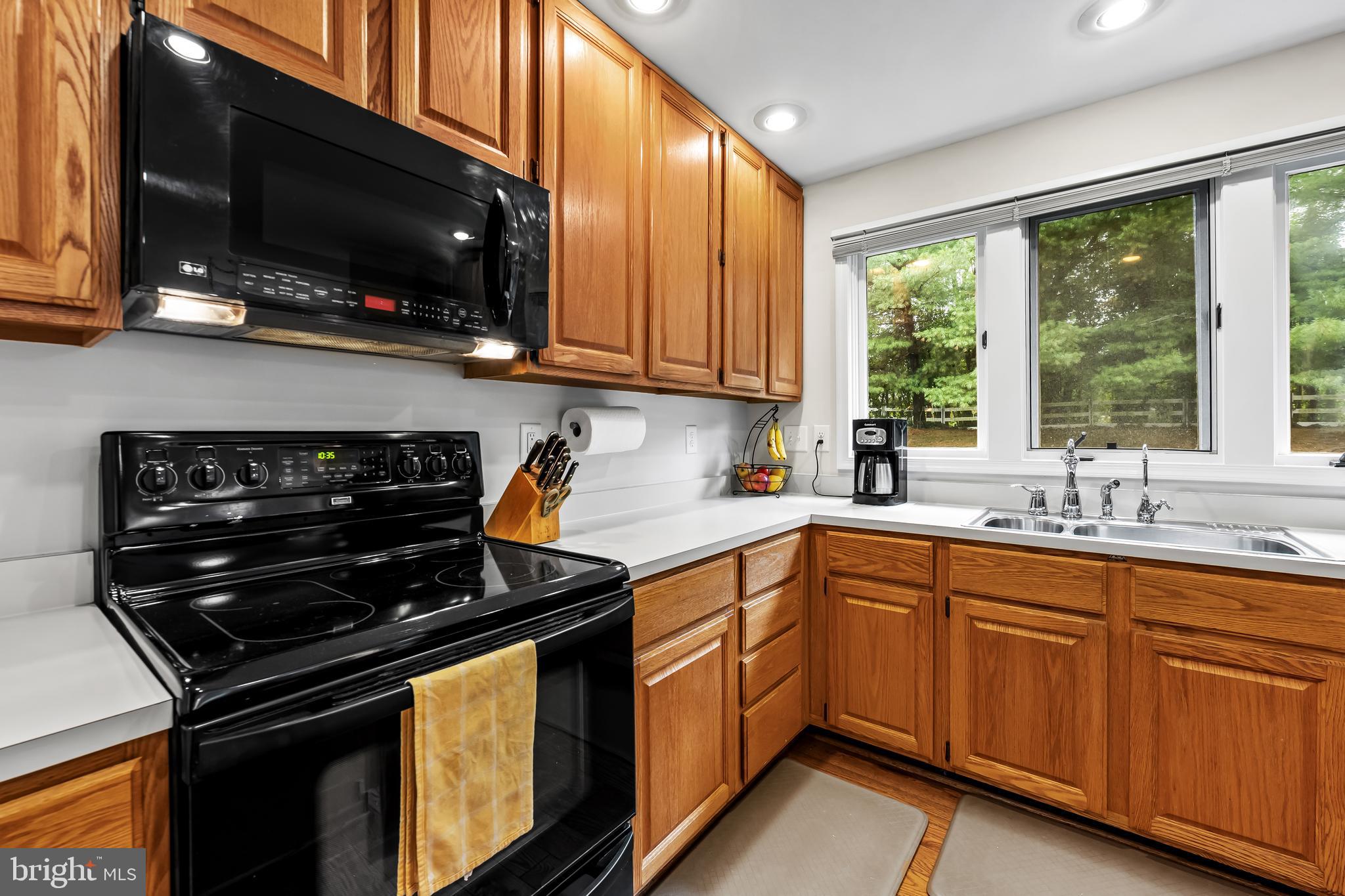 8315 Saddle Ridge Terrace Ellicott City, MD 21043 - Photo 17 of 62 a kitchen with stainless steel appliances a stove sink and microwave