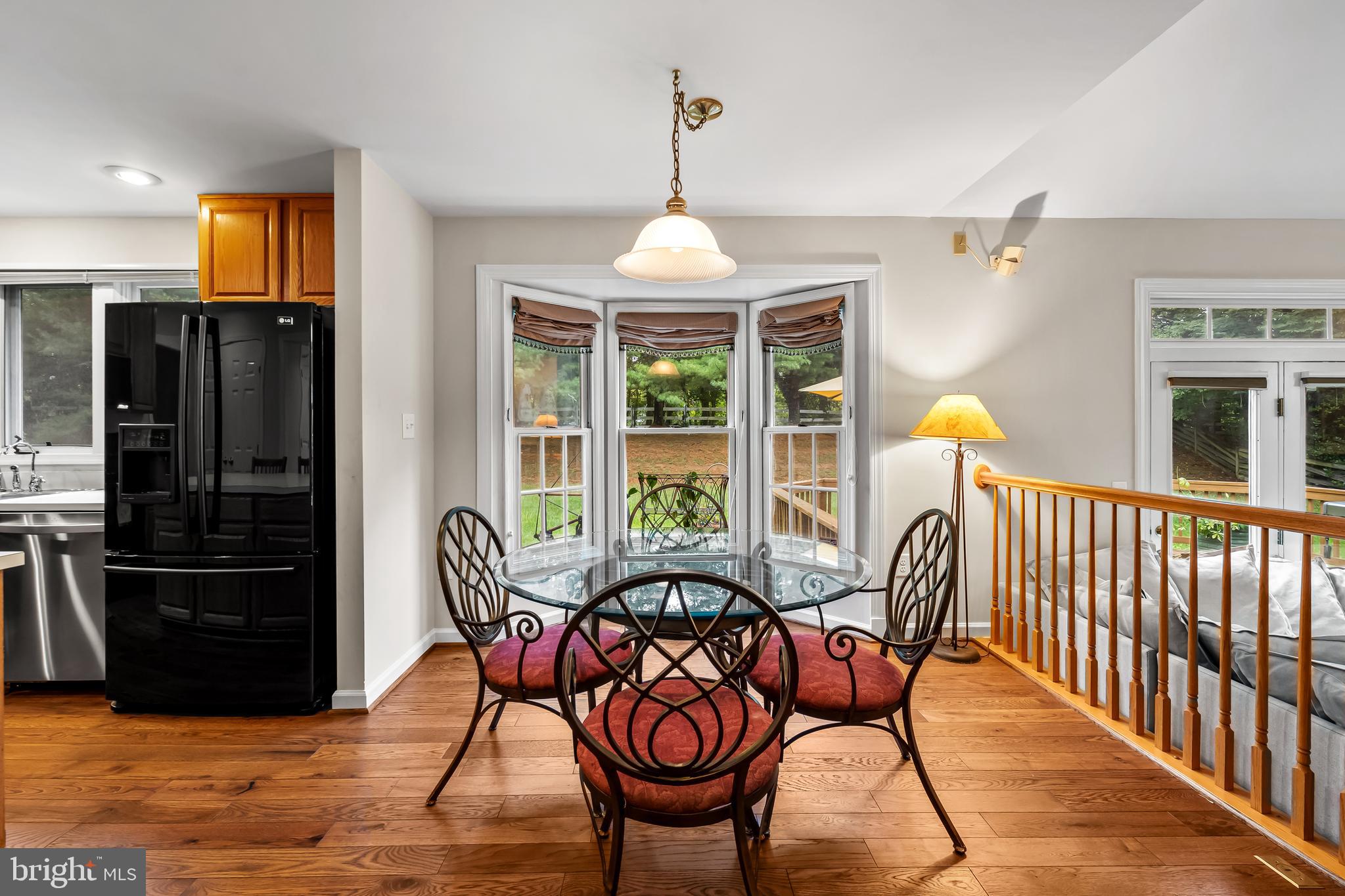 8315 Saddle Ridge Terrace Ellicott City, MD 21043 - Photo 20 of 62 a view of a dining room with furniture window and wooden floor
