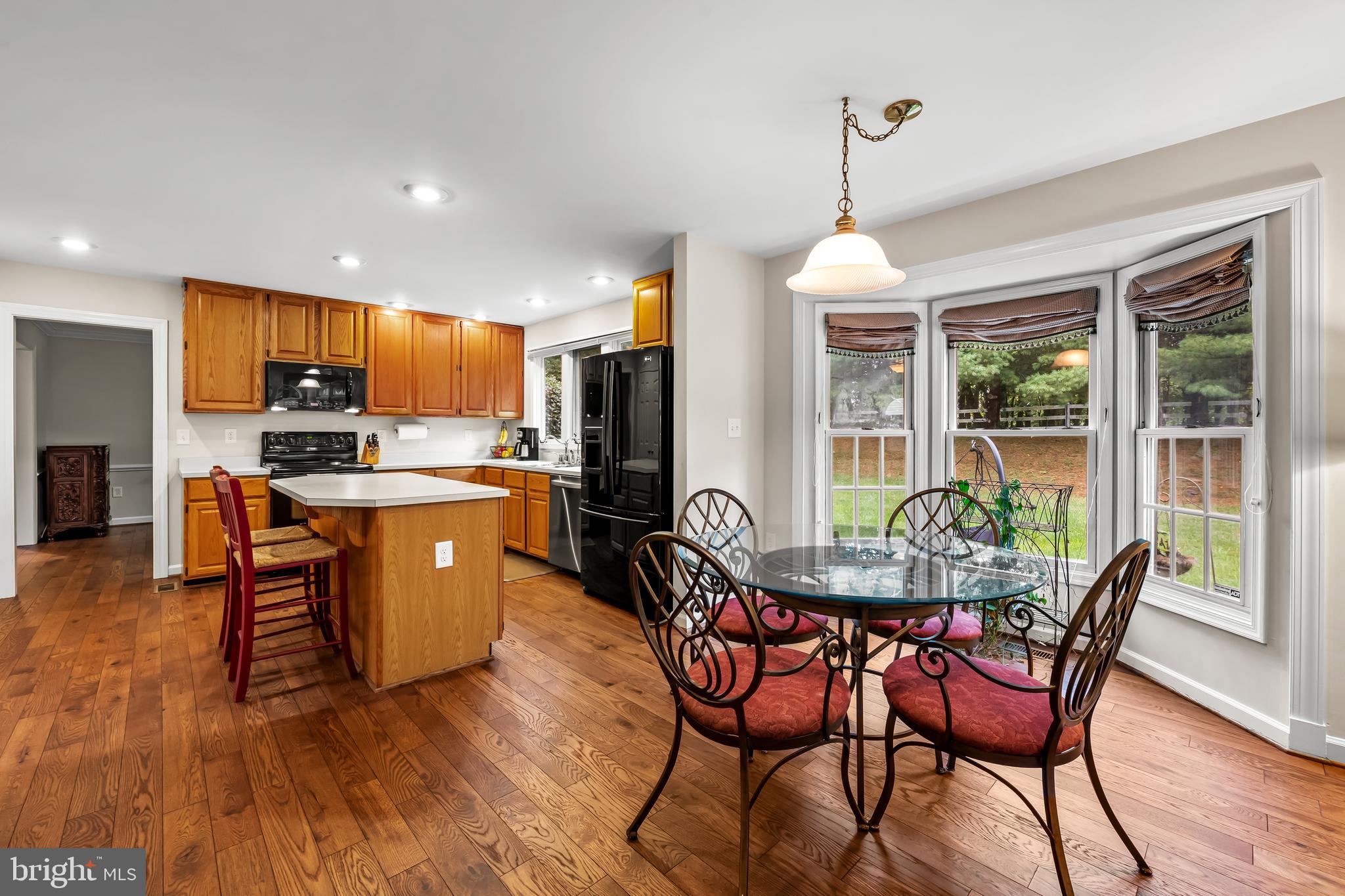 8315 Saddle Ridge Terrace Ellicott City, MD 21043 - Photo 21 of 62 a dining room with furniture window wooden floor and a chandelier
