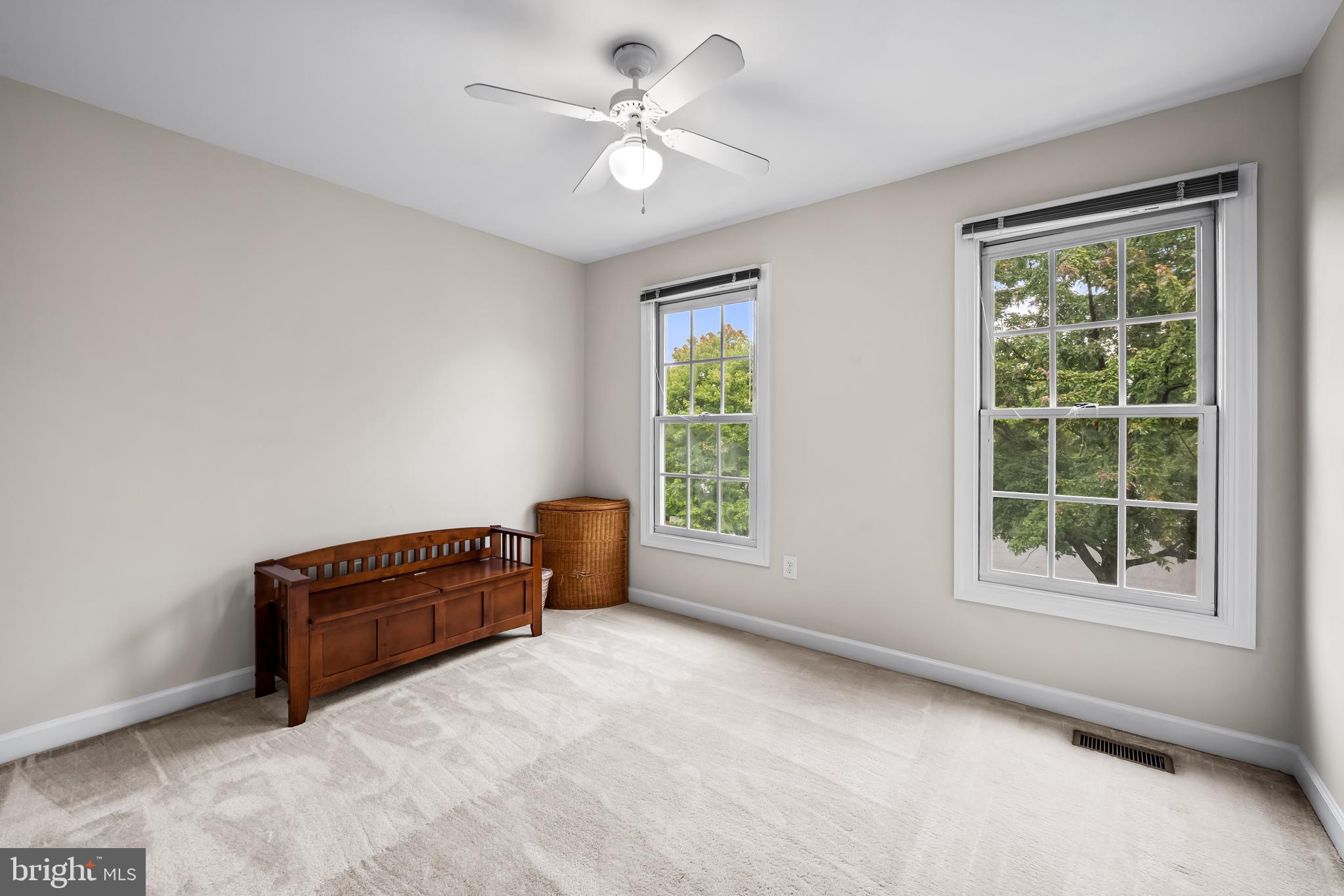8315 Saddle Ridge Terrace Ellicott City, MD 21043 - Photo 28 of 62 an empty room with windows and ceiling fan
