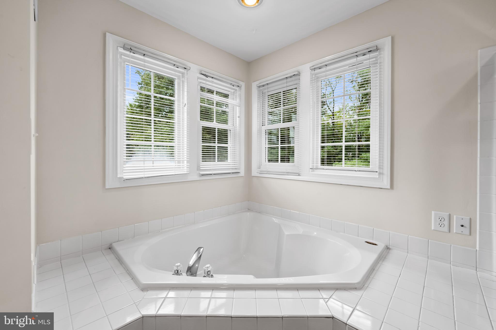 8315 Saddle Ridge Terrace Ellicott City, MD 21043 - Photo 39 of 62 a white bath tub sitting in a bathroom next to a window