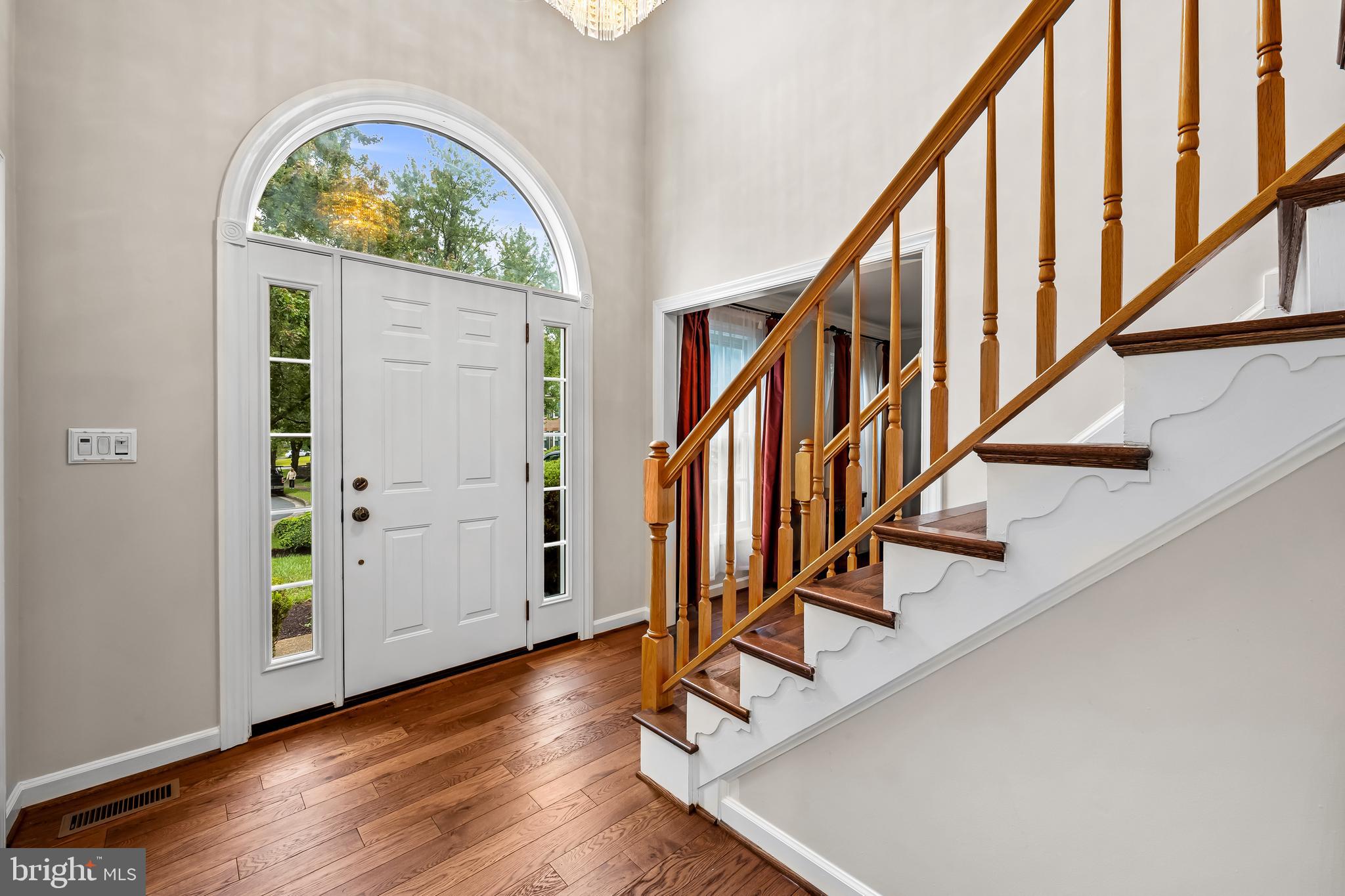 8315 Saddle Ridge Terrace Ellicott City, MD 21043 - Photo 5 of 62 a view of an entryway with wooden floor and windows